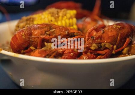 Creole Crawfish Boil with corn, potatoes and sausages Stock Photo