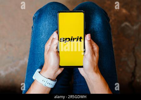 In this photo illustration, the Spirit Airlines logo is displayed on a smartphone screen. Stock Photo