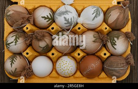 easter eggs ready to be dyed in a yellow container Stock Photo