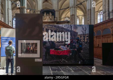 Visitors view winning pictures taken by various photojournalists from the photojournalism category of the World Press Photo contest, as they are displayed inside the Nieuwe Kerk church in Amsterdam Netherlands. The exhibition presents the winning photographs of the latest edition of the annual international photojournalism contest, the longest-running and most prestigious in the world. Stock Photo