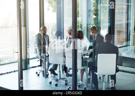 Their meeting process works every single time. a team of professionals having a meeting in the boardroom at work. Stock Photo