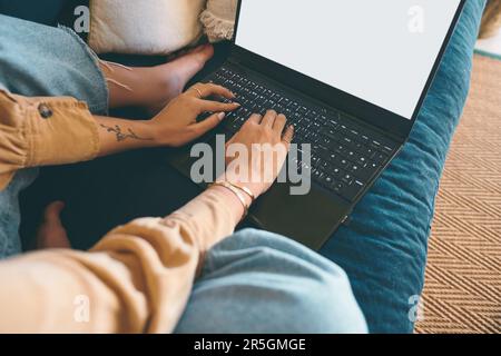 For every question, the internet has an answer. an unrecognisable woman using a laptop on the sofa at home. Stock Photo