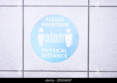 Lets follow the rules please. a social distancing sign at the airport. Stock Photo