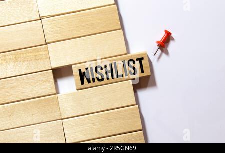 WISHLIST written text in small notebook on black background. Stock Photo