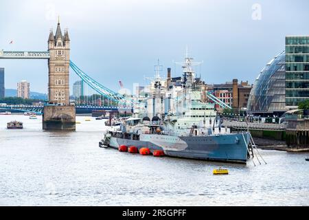 LONDON, ENGLAND - AUGUST 9th, 2018: View of HMS Belfast on the Thames, Tower bridge and the curved glass building in spherical shape of the City Hall Stock Photo
