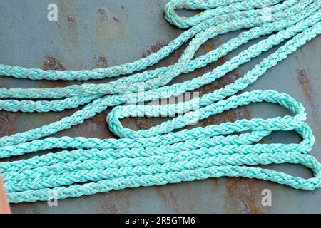 Old, frayed Blue Rope on the deck of a ship Stock Photo