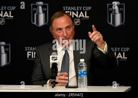 St. Louis Blues president John Davidson (L) NHL Commissioner Gary Bettman  (C) and team owner Dave Checketts, listen as former St. Louis Blues  defenseman and hockey's newest member of the Hockey Hall