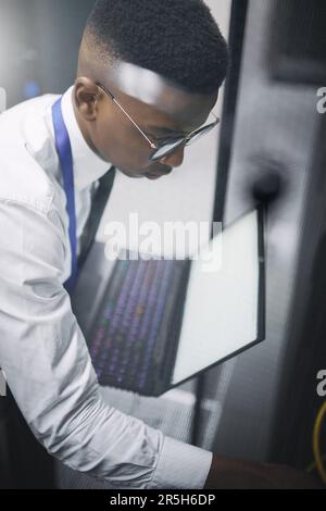 Find what brings you joy. a young male technician working in a server room. Stock Photo