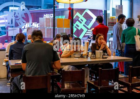 Chinese People Having Lunch at The Tsim Chai Kee Restaurant, Hong Kong, China. Stock Photo