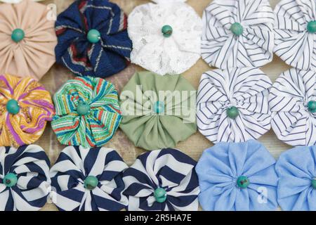 The yo-yo handicraft is made up of several small bundles of clothes that, sewn together, give rise to flowers of different colors. interiors in rio de Stock Photo