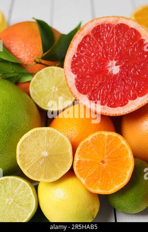 Different citrus fruits with fresh leaves, closeup Stock Photo