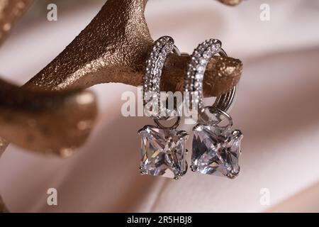 Elegant jewelry. Stylish presentation of luxury earrings on holder, closeup Stock Photo