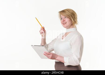 Portrait happy mature businesswoman holding clipboard and pointing up finger with pencil. Caucasian ethnicity blonde female 49 years old Stock Photo