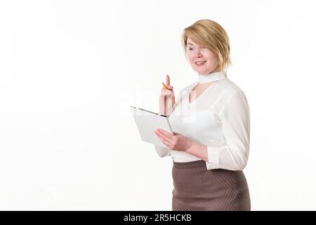 Smiling woman holding clipboard with pencil and happy looking away, standing against white background. Copy space. Blonde adult business woman Stock Photo
