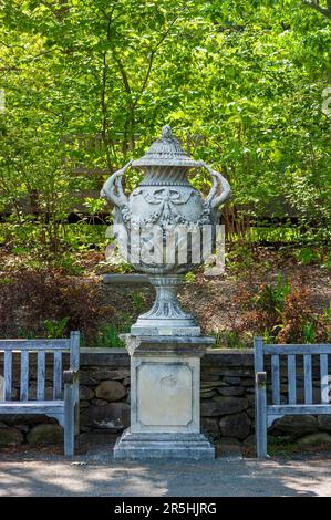 Welsh Talbot Vase - a decorative stone urn on a plinth, in a formal garden. New England Botanic Garden at Tower Hill, Boylston, Massachusetts Stock Photo