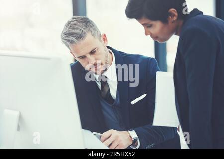 The two to take business forward. a businesswoman and businessman collaborating on a project at work. Stock Photo