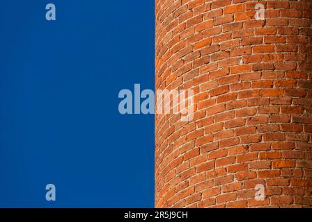 Curved brick wall with blue sky as background (with copy space) Stock Photo