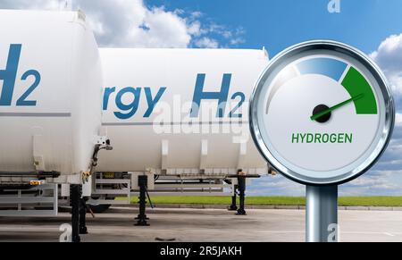 Hydrogen gauge with tree colors - gray, blue and green on a background of hydrogen tank trailers. Green fuel concept Stock Photo