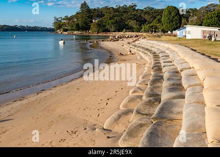 Large sandbags set along the shore edge to protect against storm damage and erosion at Simpsons Bay in Port Hacking south of Sydney, Australia Stock Photo