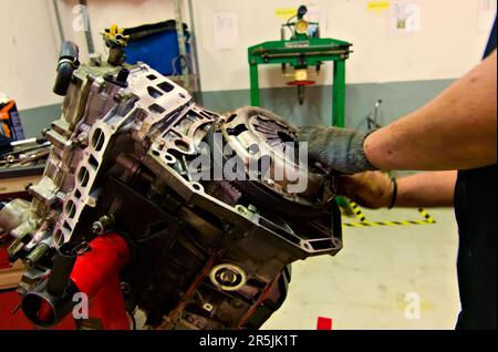 a car engine being assembled on an engine stand in a garage Stock Photo