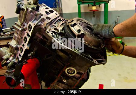 a car engine being assembled on an engine stand in a garage Stock Photo