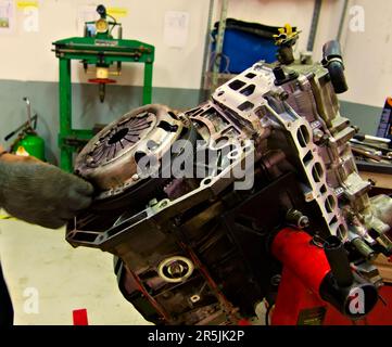 a car engine being assembled on an engine stand in a garage Stock Photo