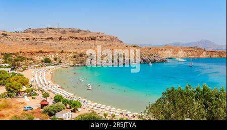 Sea skyview landscape photo Lindos bay and sea coast on Rhodes island, Dodecanese, Greece. Panorama with nice sand beach and clear blue water. Famous Stock Photo