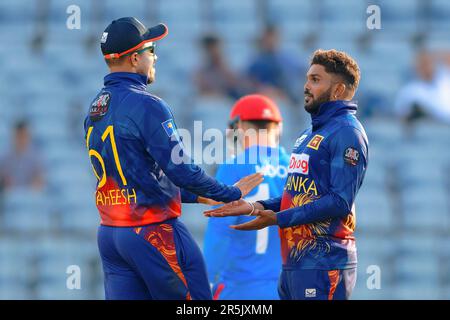 Hambantota, Sri Lanka. 04th June 2023. Sri Lanka's Wanindu Hasaranga (R) celebrates with teammate Maheesh Theekshana (L) after taking the wicket of Afghanistan's Noor Ahmad (C) during the 2nd ODI cricket match between Sri Lanka vs Afghanistan at the Mahinda Rajapaksa International Cricket Stadium in Hambantota on 04th June, 2023. Viraj Kothalwala/Alamy Live News Stock Photo