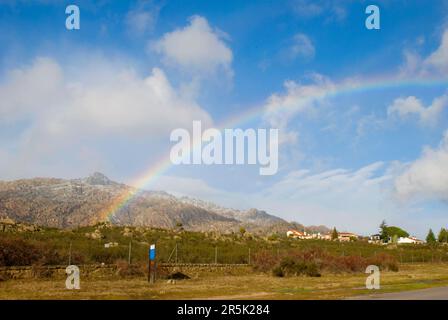 Rainbow and La Pedriza mountain. Manzanares El Real, Madrid province, Spain. Stock Photo