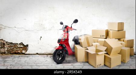 Express delivery service by motorcycle. Red motorcycle with lots of delivery boxes on the street and wall background. Stock Photo