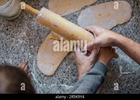 Father and son cooking together Stock Photo