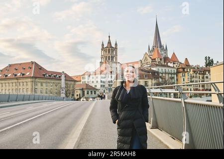 Outdoor portrait of beautiful young woman walking down the street, image taken at Pont Bessières, Lausanne, Switzerland Stock Photo