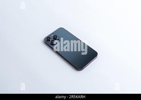 Black phone backside with three cameras and sensors. The phone is placed on the table. Isometric view Stock Photo