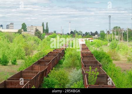 Abandoned rusty railway carriage at old lifeless railway Stock Photo