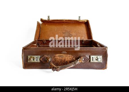 An old battered brown leather suitcase, isolated on a white background Stock Photo