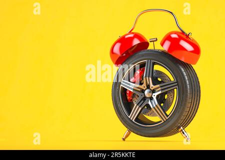 Time to change car tires or wheels. Car wheel  in the form of  alarm clock on gyellow background. 3d illustration Stock Photo