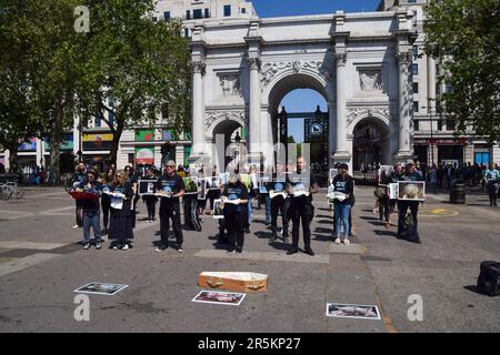 London, UK. 4th June 2023. Activists holding pictures of animals and some holding real dead animals gathered next to Marble Arch on National Animal Rights Day in remembrance of the billions of animals exploited, abused and killed by humans worldwide. Stock Photo