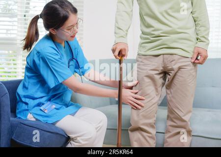 Elderly patient trying to stand and walking with caregiver nurse Stock ...