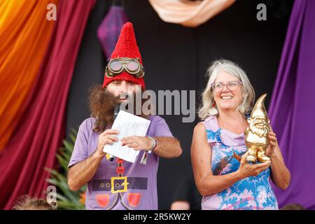 Cairns, Australia. 04th June, 2023. Australian TV personality Costa Georgiadis presents the Golden Gnome award for outstanding community and environmental effort to Bats and Trees Society of Cairns treasurer Brynn Mathews at the Cairns Eco Fiesta in the Munro Martin Parklands. Organised by the Cairns Regional Council, the Eco Fiesta is an environment and sustainability festival focused to celebrate and support far north Queensland's Great Barrier Reef and Wet Tropics Rainforests. Credit: SOPA Images Limited/Alamy Live News Stock Photo