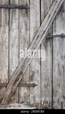 Close up photo of old wooden barn door, background or wallpaper. Stock Photo