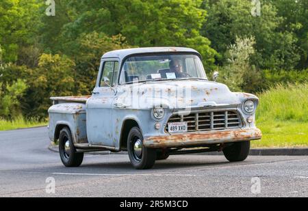 Stony Stratford,UK - June 4th 2023: 1957 old CHEVROLET pick up travelling on an English country road. Stock Photo