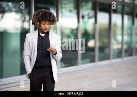 Male middle aged employee using cellphone, chatting with friends or looking for new business opportunities on Internet Stock Photo
