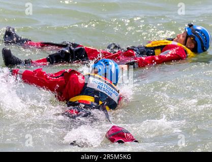 Joint emergency services display with focus on water safety. RNLI and Coastguard crews and vessels demonstrate the recovery of a victim from the sea. Stock Photo