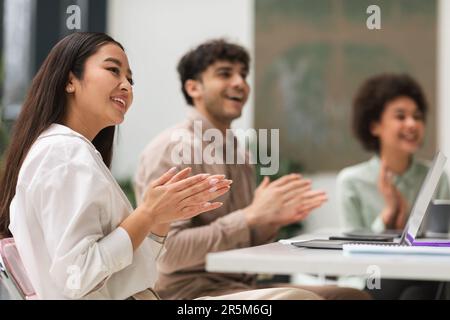 Happy Multicultural Colleagues Clapping Hands Celebrating Achievement Together In Office Stock Photo