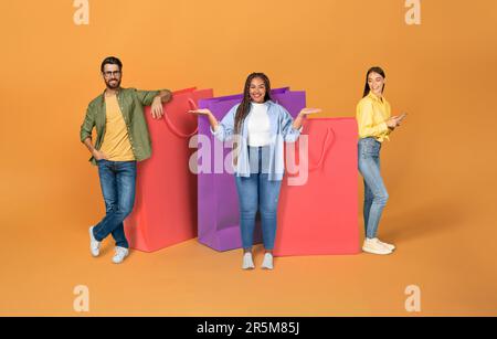 Cheerful millennials posing next to huge shopping bags, collage Stock Photo
