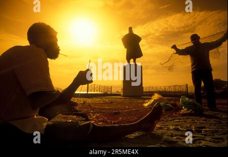 fishermen fix the fishingnet in front of the Fishmarket in the City Mindelo on the Island of Sao Pedro on the Cape Verde Islands in Africa.  Cape Verd Stock Photo