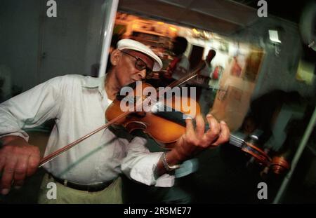 Musicien play traditional Morna or Cape Verde Fado in a Restaurant in the City Mindelo on the Island of Sao Pedro on the Cape Verde Islands in Africa. Stock Photo