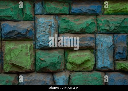 A colorful green and blue stone wall photo, background, texture. Stock Photo