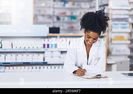 Im happy with what we have on our shelves. a confident young woman working as a pharmacist in a chemist. Stock Photo
