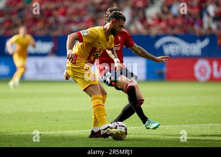 Valentín Castellanos (forward; Girona FC) and Juan Cruz (defender; CA Osasuna) in action during the Spanish football of La Liga Santander, match between CA Osasuna and Girona FC at the Sadar Stadium. Final scores; CA Osasuna  2-1 Girona FC. Stock Photo